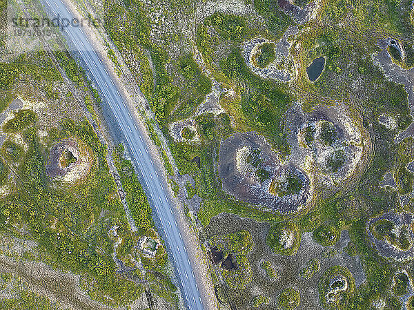 Aerial vertical view of old volcano and asphalt road  near to Myvatn lake on a summer day  Iceland  Polar Regions