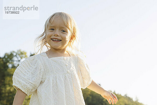 Smiling blond girl on sunny day