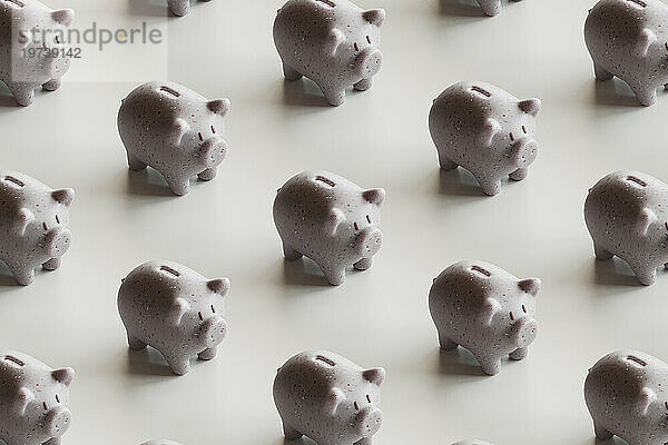 Piggy banks arranged over white background
