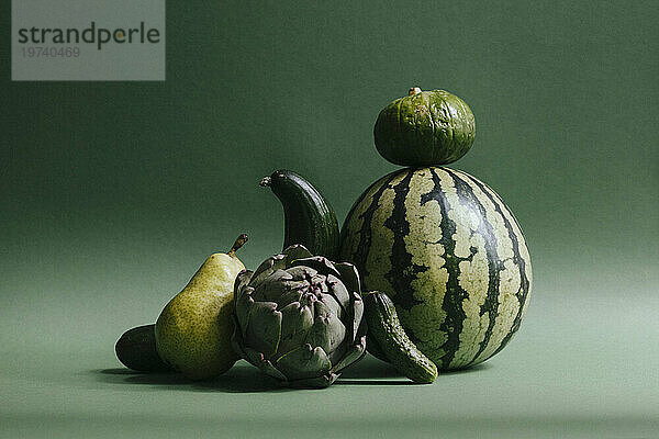Green fruits and vegetables against green background