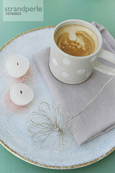 Eggshell candles  wire  napkin and mug of coffee on tray