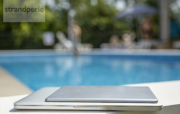 Laptop und Tablet-PC werden in der Nähe des Pools aufbewahrt