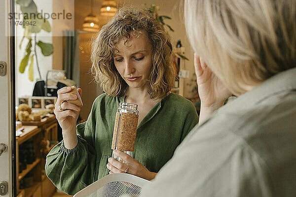 Blonde Frau wählt Waren mit Freundin im Ökoladen aus