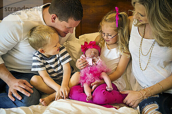 Family gathers around their new baby girl; Lincoln  Nebraska  United States of America