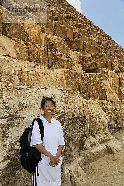 Nahaufnahme einer asiatischen Touristin  die vor der Großen Pyramide von Gizeh steht; Gizeh  Kairo  Ägypten