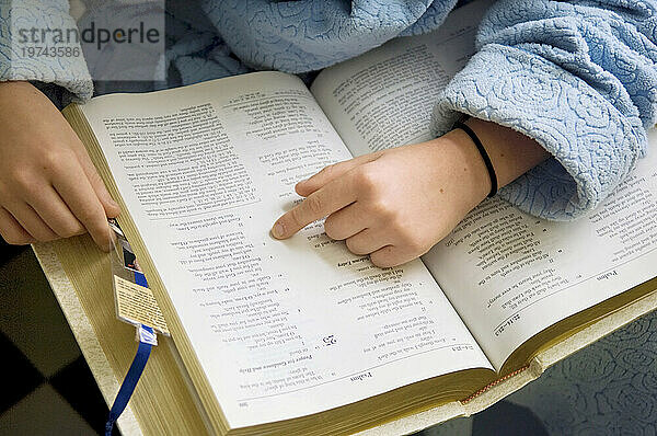 Nahaufnahme eines jungen Mädchens  das die Bibel liest; Lincoln  Nebraska  Vereinigte Staaten von Amerika