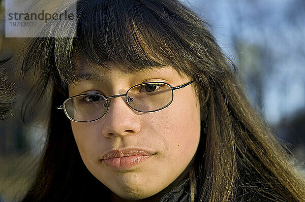 Außenporträt eines Teenager-Mädchens mit Brille und ernstem Gesichtsausdruck; Staten Island  New York  Vereinigte Staaten von Amerika