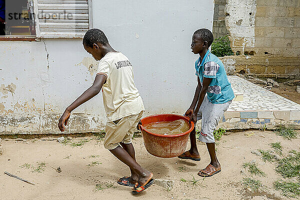 Boys fetching water in Thiaoune  Senegal  West Africa  Africa