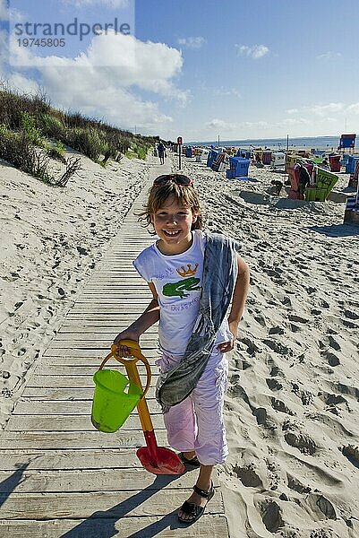 Junges Mädchen im Sommerurlaub  lachend  freudig  Sommer  Urlaub  Reise  Schaufel  Eimer  Strand  Nordsee  Deutschland  Europa