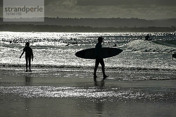 Surfer als Silhouette am Strand von Byron bay  Wassersport  Freizeit  bekannter Urlaubsort  Surfspot an der Ostküste  Queensland  Australien  Ozeanien