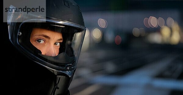 Junge schöne Frau Motorradfahrer in einem Motorradhelm  Verkehrssicherheit  Motorradausrüstung