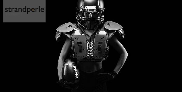 Porträt eines Mädchens in der Uniform eines American Football Spielers. Schwarzer Hintergrund. Sportliches Konzept.