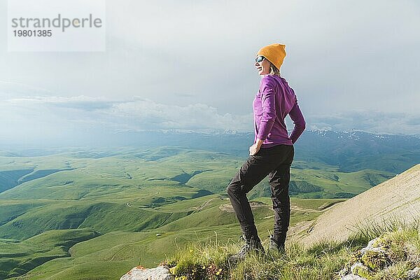 Ein Hipster Mädchen mit Strohhut und Brille in der Naturlandschaft