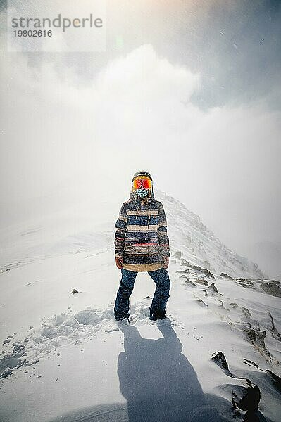 Porträt einer hübschen und aktiven Skifahrerin  die eine Maske trägt  aktiver Winterurlaub. Extrem Lifestyle Konzept