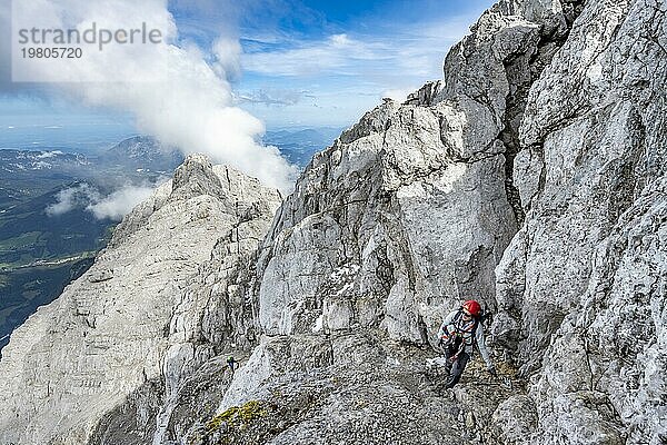 Bergsteigerin auf einem schmalen felsigen Bergweg  Watzmann Überschreitung zur Watzmann Mittelspitze  Nationalpark Berchtesgaden  Berchtesgadener Alpen  Bayern  Deutschland  Europa