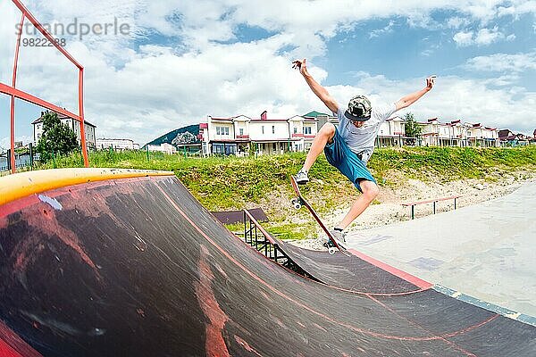 Junge macht einen Trick mit einem Sprung auf der Rampe im Skatepark. Foto mit Platz für Copyspace