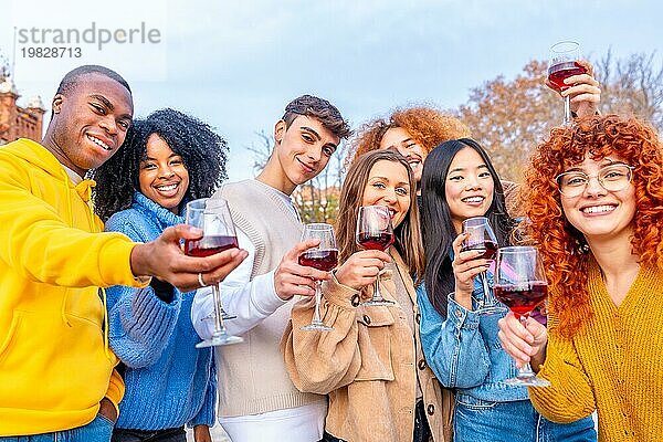 Studenten feiern die Winterferien mit Rotwein in einem Stadtpark