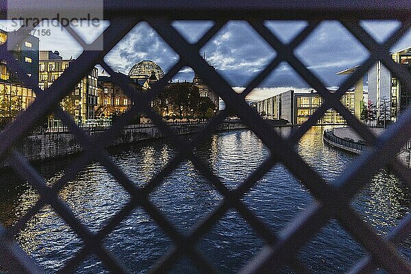 The Reichstag can be seen through a fence in Berlin at blue hour  15/11/2023