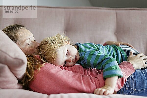 Topic: Mother and child cuddling on a sofa