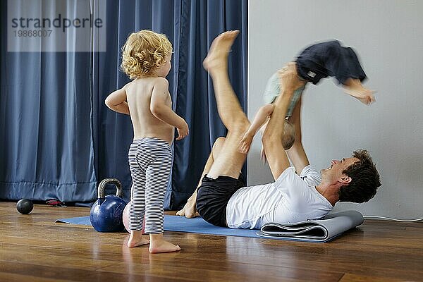Topic: Father doing gymnastics with children