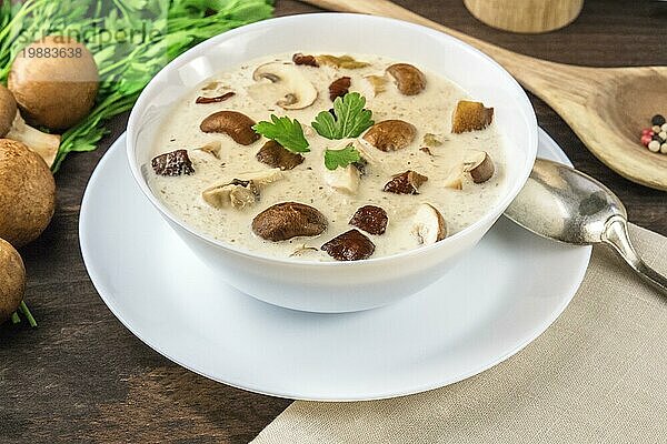 Pilzsuppe mit Champignons und Pfeffer auf einem dunklen  rustikalen Holzhintergrund  selektiver Fokus