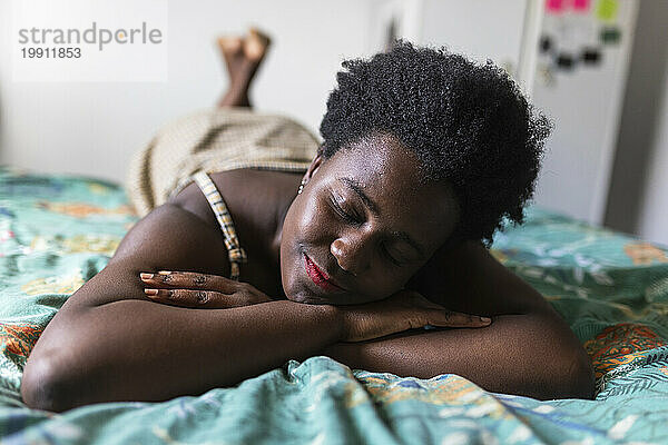 Young woman resting on bed in bedroom at home