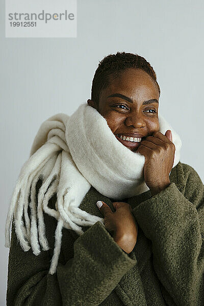 Smiling woman wearing scarf against white background