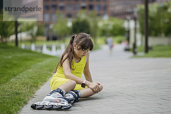 Girl falling and injuring herself roller skating at the city park