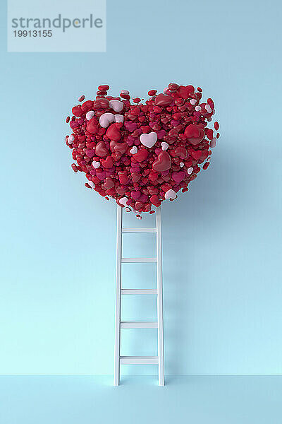 White ladder reaching to heart shaped balloon against blue background