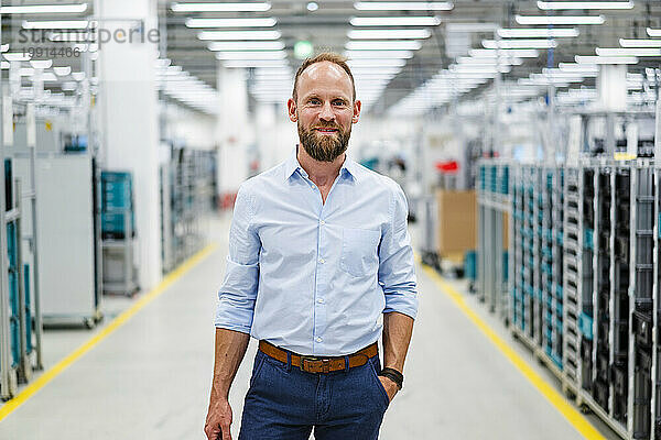 Portrait of a confident businessman in a factory