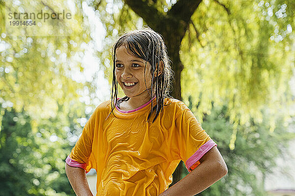 Smiling girl wearing wet clothes at park