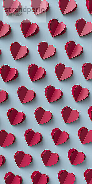 Seamless pattern of paper hearts on blue background