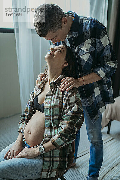 Mann tröstet schwangere Frau zu Hause