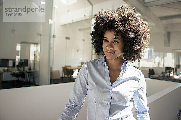 Businesswoman with curly hair at office