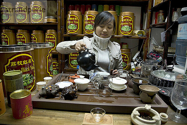 Eine Frau serviert Tee in einem Teeladen in Peking  China.