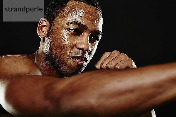 Ein junger afroamerikanischer Boxer im Studio