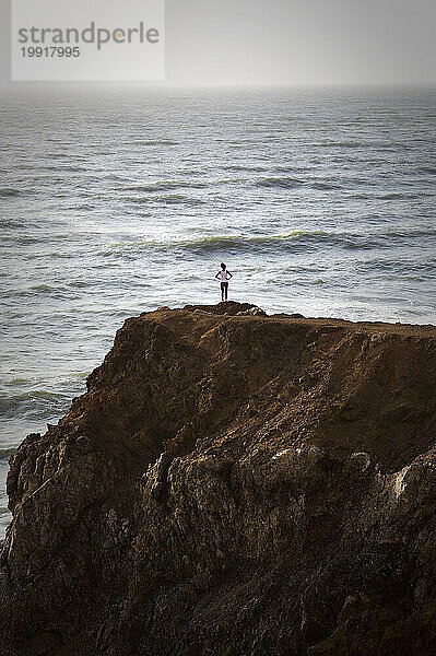 Eine Frau blickt in Pacifica  Kalifornien  auf den Ozean.