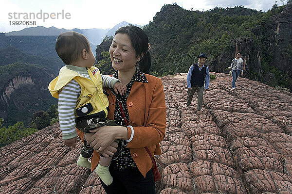 A mother hiking with child in Yunnan Province  China