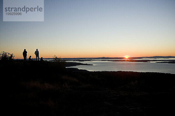 Wanderer beobachten den Sonnenaufgang über der Penobscot Bay  Maine. (Silhouette)