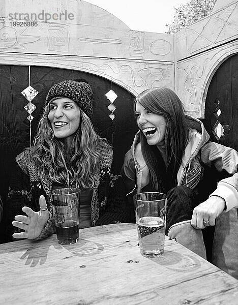 Zwei Frauen lachen beim Biertrinken