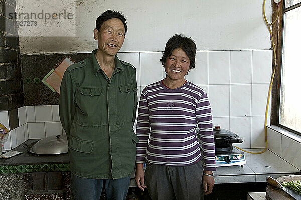 A man and woman in a kitchen in Yunnan Province  China.