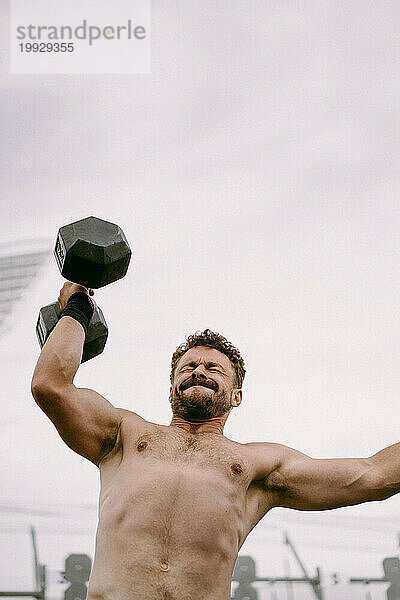 CrossFit-Wettbewerb für Männer. Ein Mann hebt eine Hantel.