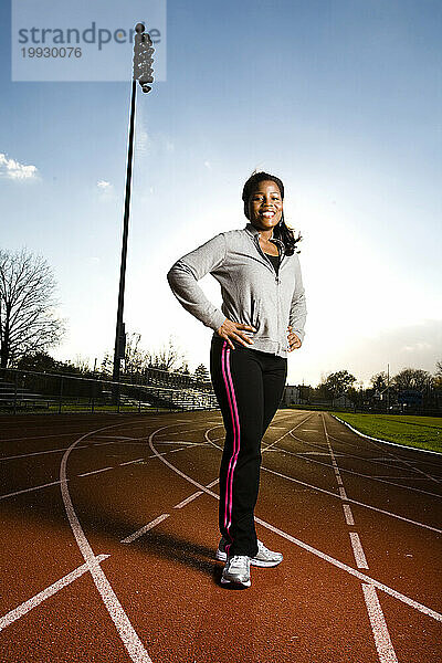 34-year-old African American woman exercises on a school track near Philadelphia.
