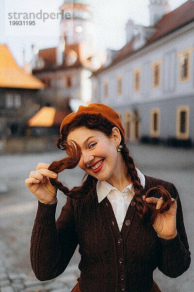 Junge Frau in Retro-Kleidung in der Sonne in einer alten europäischen Stadt