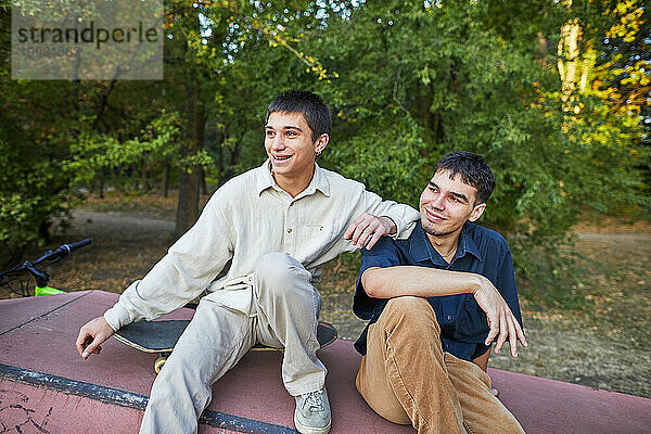 zwei lächelnde Freunde in einem Skeet-Park