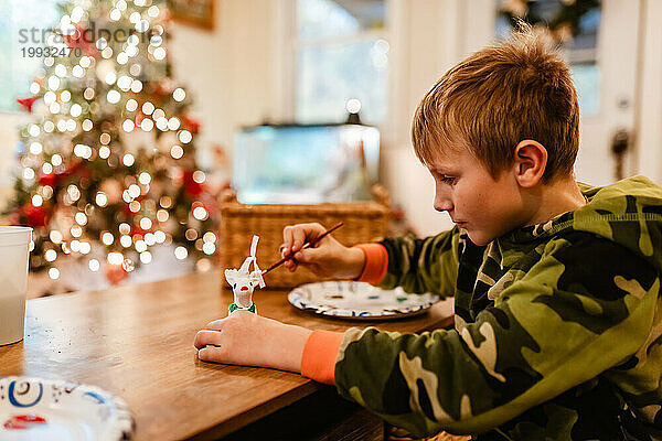 Kind malt Weihnachtsschmuck zu Hause