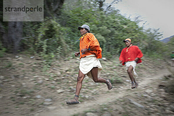 Tarahumara-Indianer gleiten einen Feldweg hinunter