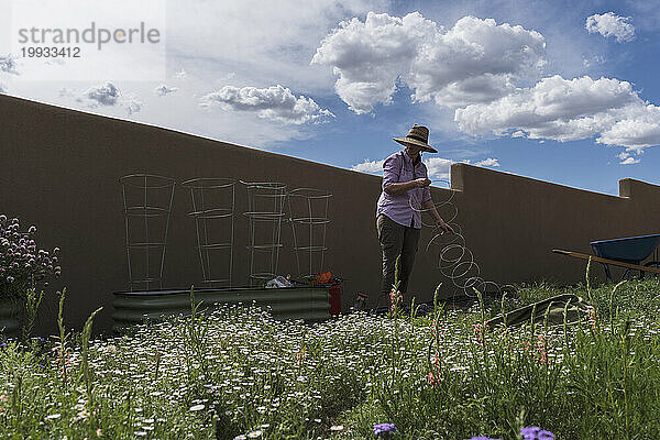 USA  New Mexico  Santa Fe  Frau bei der Gartenarbeit in der High Desert