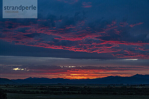 Wunderschöner Sonnenuntergang über den Silhouetten der Berge