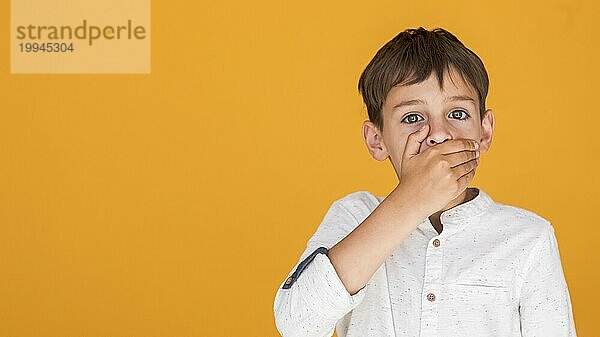 Kind bedeckt seinen Mund mit Kopierraum